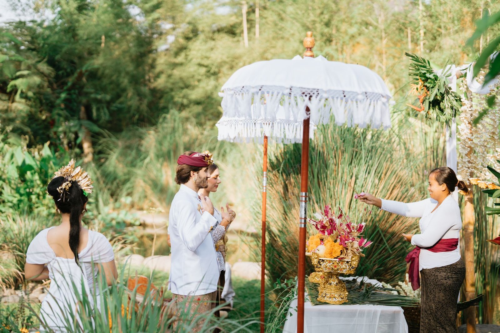 Balinese blessing ritual with ceremonial offerings